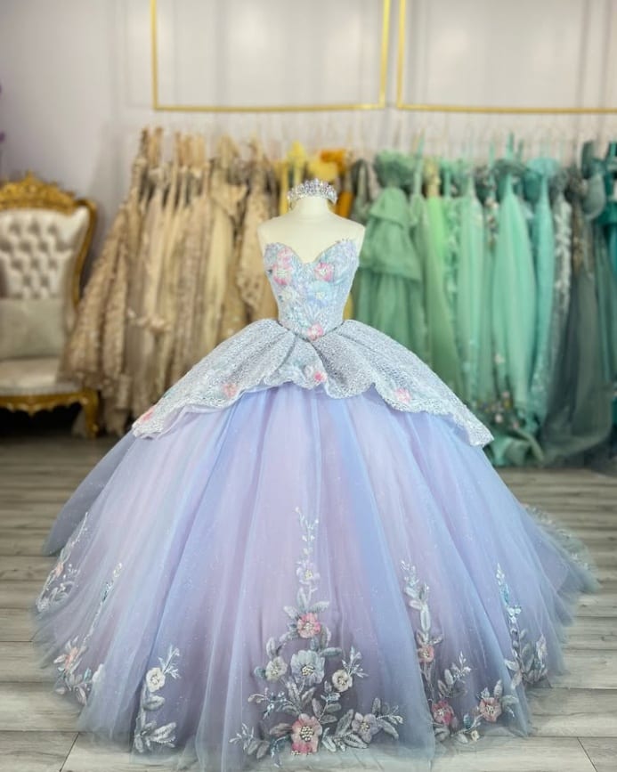 Lavender quinceañera ball gown with embroidered flowers and a peplum bodice